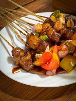 skewered beef meat on a grill, or barbecue bbq, locals called it beef satay showcasing their vibrant glaze and texture. Perfect representation of barbecue culture, grilling cuisine, and outdoor cooking enjoyment.