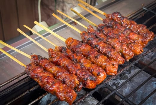skewered beef meat on a grill, or barbecue bbq, locals called it beef satay showcasing their vibrant glaze and texture. Perfect representation of barbecue culture, grilling cuisine, and outdoor cooking enjoyment.