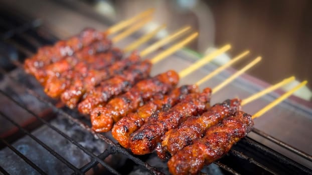 skewered beef meat on a grill, or barbecue bbq, locals called it beef satay showcasing their vibrant glaze and texture. Perfect representation of barbecue culture, grilling cuisine, and outdoor cooking enjoyment.