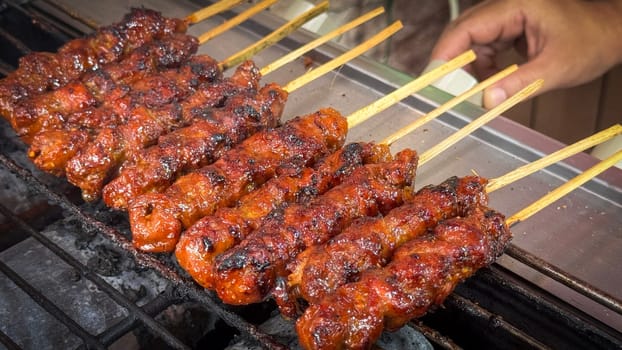 skewered beef meat on a grill, or barbecue bbq, locals called it beef satay showcasing their vibrant glaze and texture. Perfect representation of barbecue culture, grilling cuisine, and outdoor cooking enjoyment.