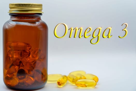 Close-up of an amber jar filled with Omega-3 capsules, alongside scattered capsules and a "Omega 3" label on a light background, promoting health supplements.