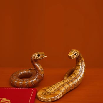 two wooden snakes horoscope chinese new year holiday wallet wealth. High quality photo