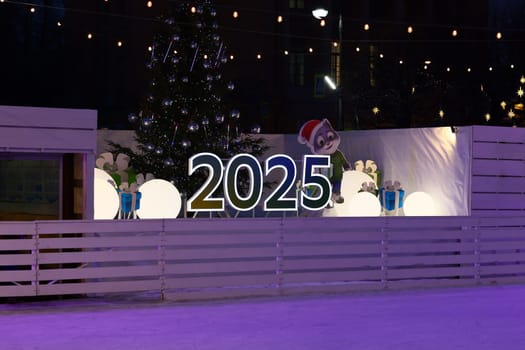 A festive 2025 sign is showcased with vibrant decorations and a charming Christmas tree, enhancing the holiday spirit