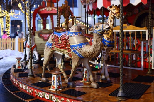 A vibrant carousel featuring a camel and beautifully designed animals, perfect for festive occasions.