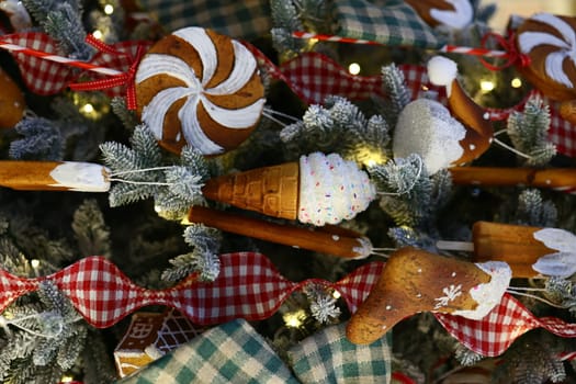 A vibrant and colorful Christmas tree beautifully adorned with delightful candythemed ornaments and cozy fabrics