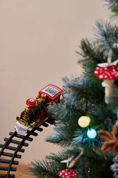 A delightful toy train circles around a beautifully decorated Christmas tree, evoking the true holiday spirit