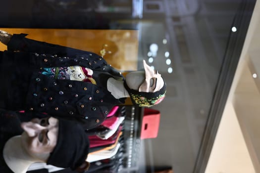 Stylish mannequins elegantly showcasing a variety of modern clothing and accessories in an inviting retail setting