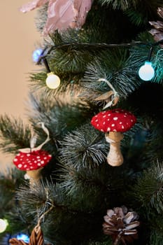 A festive Christmas tree is adorned with colorful red mushroom ornaments and surrounded by twinkling lights