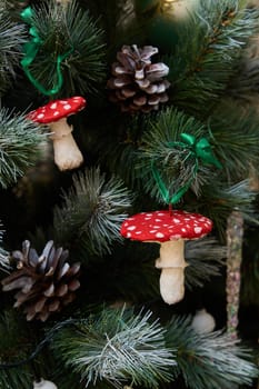 Charming and adorable mushroom ornaments beautifully adorn a decorated Christmas tree embellished with pinecones