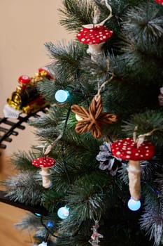 A beautifully decorated Christmas tree with whimsical mushroom ornaments and twinkling colorful lights
