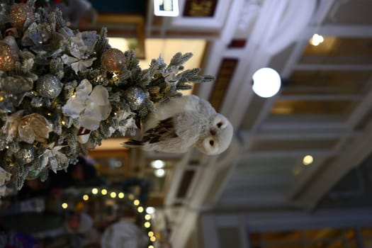 A beautifully decorated holiday scene featuring a charming owl elegantly perched among vibrant festive decorations