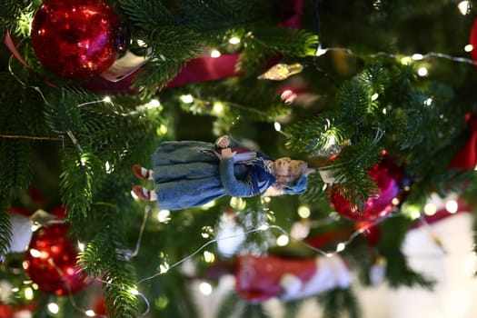 A delightful Christmas tree ornament is lovingly nestled among a variety of festive decorations and trinkets