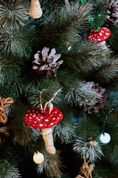 A beautifully decorated Christmas tree adorned with charming red mushroom ornaments and natural pinecones