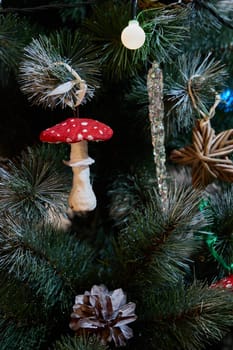 A beautifully adorned Christmas tree that showcases unique ornaments such as a mushroom and pinecone