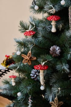 A decorated Christmas tree features charming mushroom ornaments and lovely pinecones, creating a festive vibe