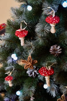 A beautifully festive Christmas tree is adorned with whimsical red mushroom ornaments along with lovely pine cones