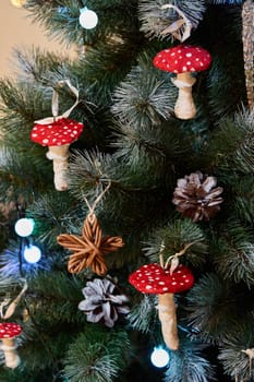 The festive Christmas tree is beautifully adorned with unique red mushroom ornaments and decorative pine cones