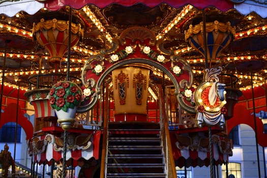 An enchanting carousel adorned with bright lights and intricate designs, perfect for festive occasions.