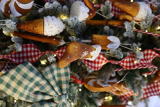 A beautifully decorated Christmas tree featuring delightful baked good ornaments and traditional ribbon.