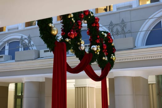Gorgeously designed festive wreaths elegantly adorned with beautiful red drapes, ideal for capturing the holiday spirit