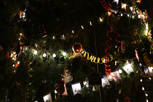 A beautifully decorated Christmas tree with lights, ribbons, and ornaments creating a festive atmosphere.