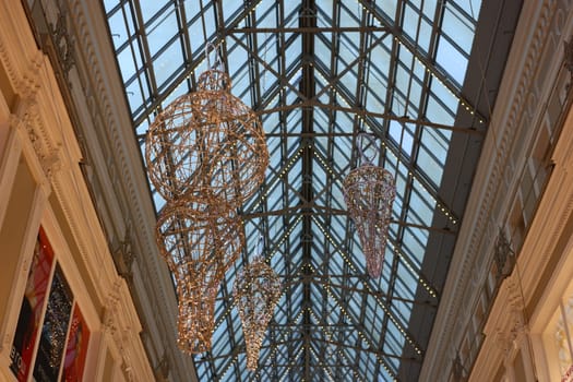 A stunning architectural view featuring a luxurious glass ceiling beautifully adorned with intricate decorations