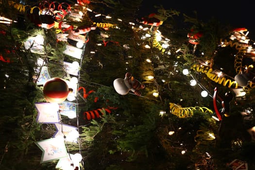 A beautifully decorated Christmas tree adorned with numerous vibrant ornaments and shimmering twinkling lights