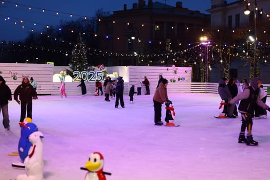 A vibrant and lively night scene of ice skaters joyfully enjoying a festive atmosphere filled with twinkling lights