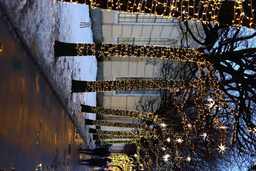 A beautifully snowcovered pathway adorned with mesmerizing lights, creating a truly magical winter atmosphere