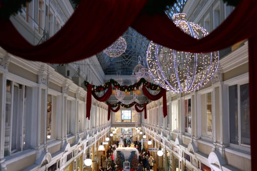 A beautifully decorated shopping mall adorned with colorful Christmas lights and ornaments, capturing holiday joy