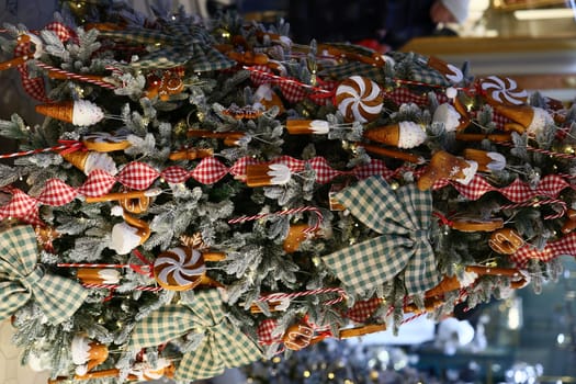 A beautifully decorated Christmas tree adorned with colorful candy, shiny bows, and delightful holiday treats