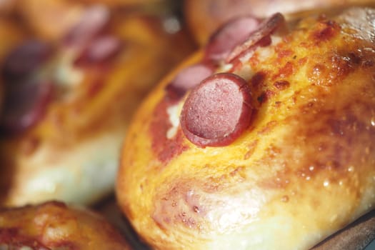 These warm baked buns filled with savory sausage slices are perfect for delightful snacks