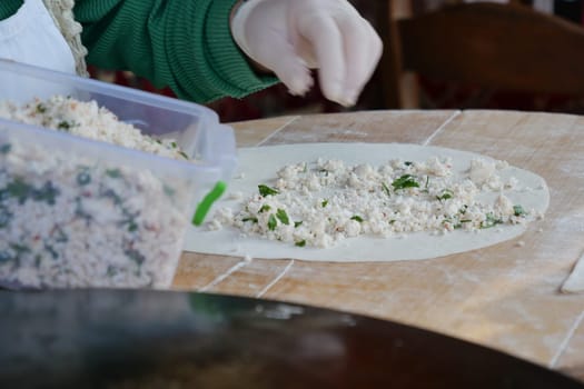 A skilled hand expertly prepares premium dough with fresh ingredients for delicious treats
