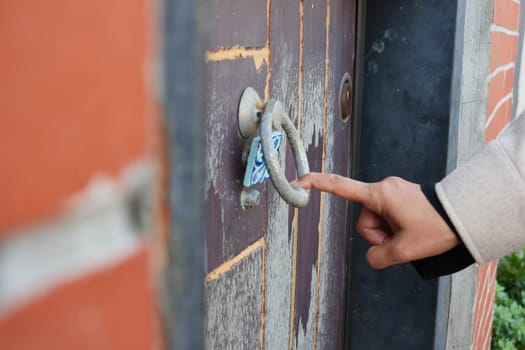 women hand knock the door.