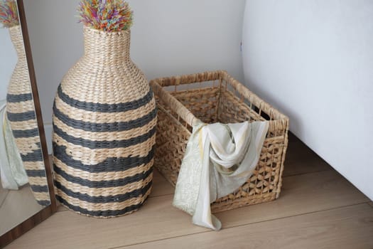 Stylish woven basket with an elegant decorative vase, ideal for modern interior design