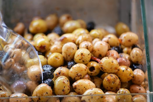 These marinated olives are now ready for serving in a clear container, inviting all to enjoy