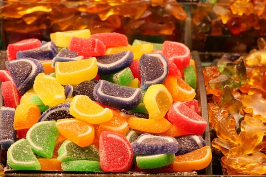 sugar coated jelly beans in the form of colored sliced fruit.