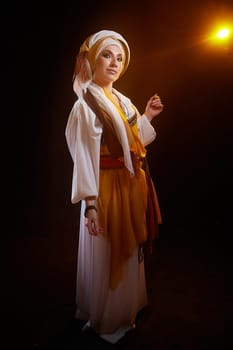 A young woman dressed in stylized national attire stands elegantly, embodying the essence of Rebekah from the Christian tradition.