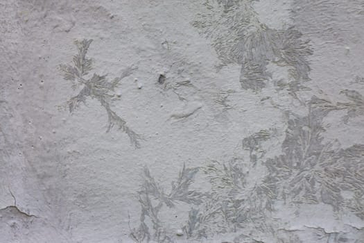 Beautiful patterns on a concrete wall from damage to gray plaster.