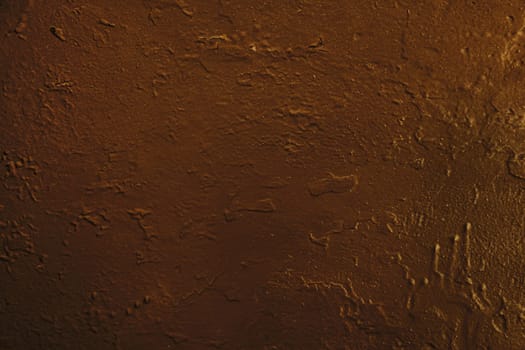 Concrete wall surface with old brown damaged paint.Dark brown concrete wall.