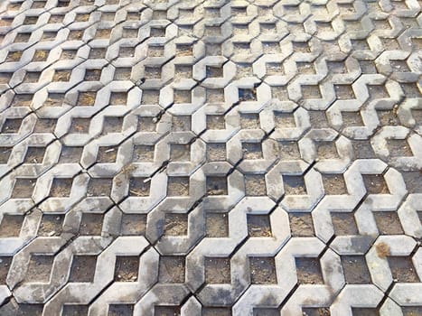 Geometric pavement features a unique hexagon pattern made of concrete blocks, providing a textured backdrop with space for additional design elements.