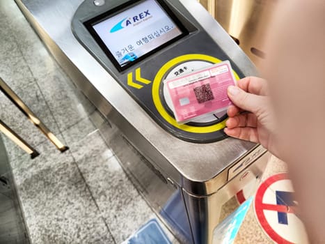 Seoul, Republic of Korea - October 30, 2024:A person scans a transport card at the metro entrance in Seoul, Republic of Korea, facilitating access to the subway system.