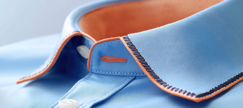 Light blue shirt with contrasting orange lining and stitching detail, showcasing high quality tailoring and men's fashion