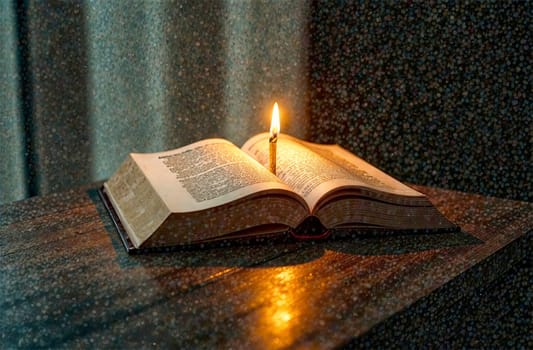 An open book rests on a wooden table, softly lit by a candle in a quiet, dimly lit space, creating a peaceful ambiance for reflection.
