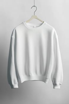 White sweatshirt hanging on a wooden hanger, perfect for showcasing your designs