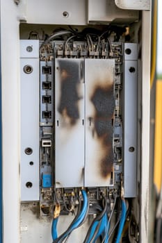 Close up of a damaged electrical panel with burn marks, highlighting the dangers of electrical faults