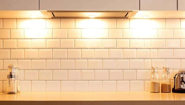 Spotlights illuminating white subway tiles in a modern kitchen create a clean, bright, and welcoming atmosphere