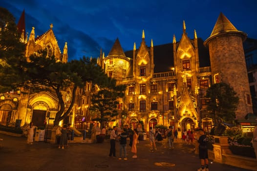 A stone medieval castle in a French village in the Ba Na Hills Tourist Park in the evening. Da Nang, Vietnam - September 13, 2024