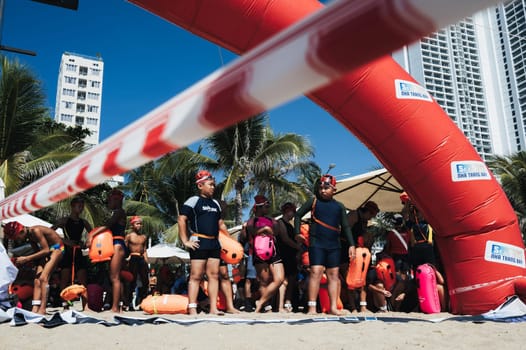 Sea Star competitions. Asian children in bathing suits waiting for the start of the swim in the sea. Swimming competitions in the sea are held on Nha Trang beach. Nha Trang, Vietnam - July 25, 2024.