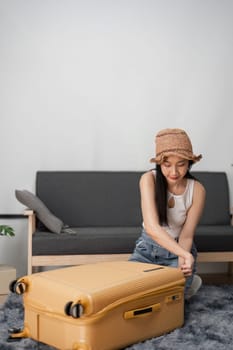 A young woman prepares for her journey, packing a suitcase in a stylish living room, ready for her travel adventure.